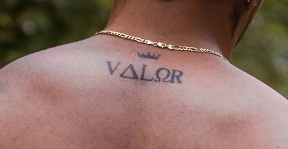 A VALOR crown tattoo across a rep's upper back — the team's mark